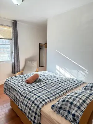 a bedroom with a bed with a pillow on it at Cozy private room in downtown Flushing in Queens