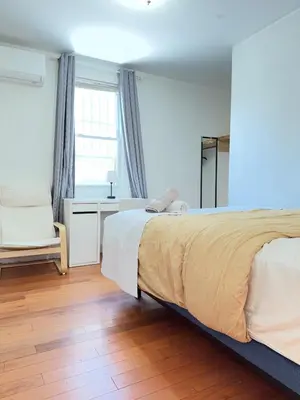 a bedroom with a bed and a desk and a window at Cozy private room in downtown Flushing in Queens