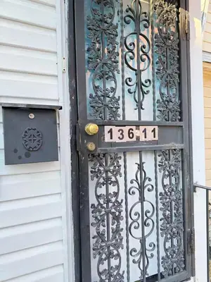 a door with a sign in front of it at Cozy private room in downtown Flushing in Queens