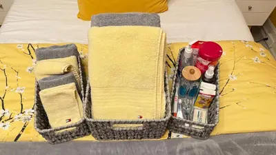 a bed with two baskets on top of it at Sunshine Dream - Deluxe Double Room in Private House - NYC in Sunnyside