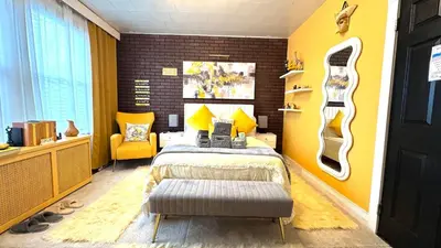 a bedroom with a bed and a yellow wall at Sunshine Dream - Deluxe Double Room in Private House - NYC in Sunnyside