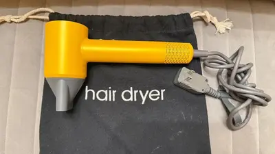 a yellow hair dryer and a pair of scissors at Sunshine Dream - Deluxe Double Room in Private House - NYC in Sunnyside
