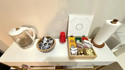 a white table with a box of food on it at Sunshine Dream - Deluxe Double Room in Private House - NYC in Sunnyside