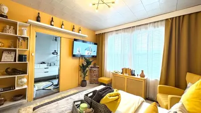 a living room with yellow walls and a tv at Sunshine Dream - Deluxe Double Room in Private House - NYC in Sunnyside