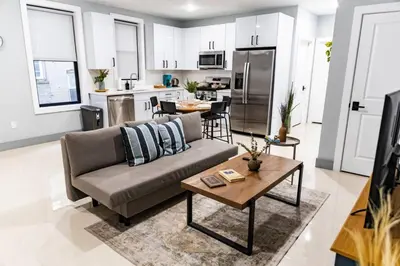 a living room with a couch and a table at City Life-2 Bedrooms-Free Indoor Parking-20minNYC in West New York