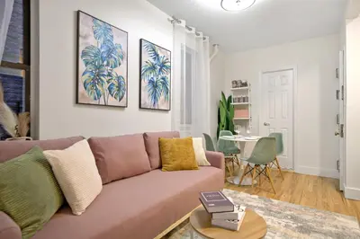 a living room with a couch and a table at Bright & Cozy 2BD in Upper East Side in New York