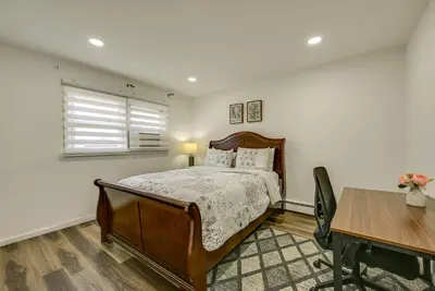 a bedroom with a bed and a table and a desk at Walk to Public Transit Apt Next to Lincoln Park in Jersey City