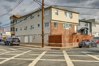 a house on a street with cars parked in front of it at Walk to Public Transit Apt Next to Lincoln Park in Jersey City