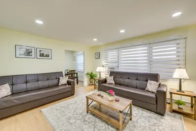 a living room with two couches and a coffee table at Stay and Play in Jersey City! Walk to PATH and Park in Jersey City