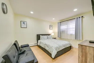 a bedroom with a bed and a couch at Stay and Play in Jersey City! Walk to PATH and Park in Jersey City