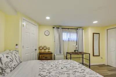 a bedroom with a bed and a clock on the wall at Walk to Lincoln Park Jersey City Commuter Apt! in Jersey City