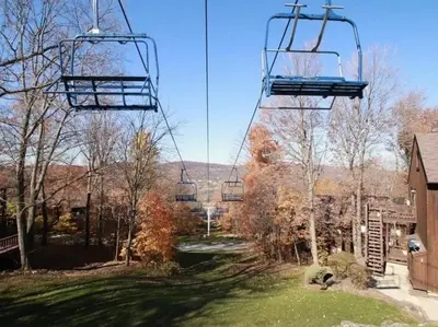 a gondola lift in the middle of a yard at Luxe 10 guest Ski Cabin - Snowboarding Hiking Pools Golf Tennis in Vernon Township