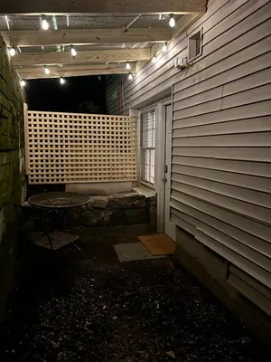 a dark room with a table next to a wall at Private, Cozy Studio in Downtown Stamford, CT in Stamford