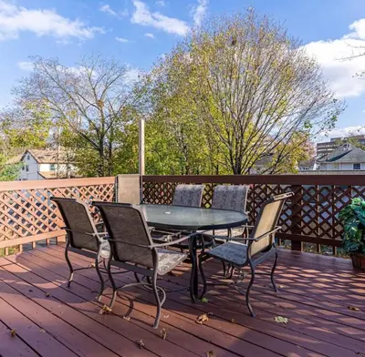 a patio table and chairs on a wooden deck at Private, Cozy Studio in Downtown Stamford, CT in Stamford