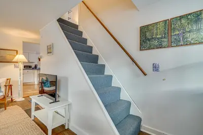 a staircase in a home with a blue carpet at 12 Mi to Bromley Mtn Ski Resort Quiet Hideaway in Manchester Center