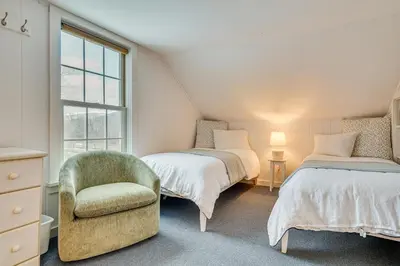 a bedroom with two beds and a chair and a window at 12 Mi to Bromley Mtn Ski Resort Quiet Hideaway in Manchester Center