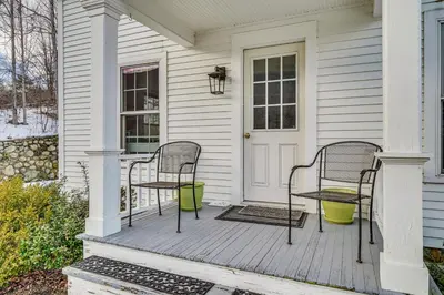 two chairs and a table on a porch of a house at 12 Mi to Bromley Mtn Ski Resort Quiet Hideaway in Manchester Center