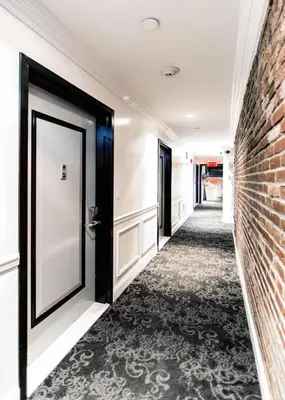 a hallway with a door and a brick wall at East Village by Vibe I in New York