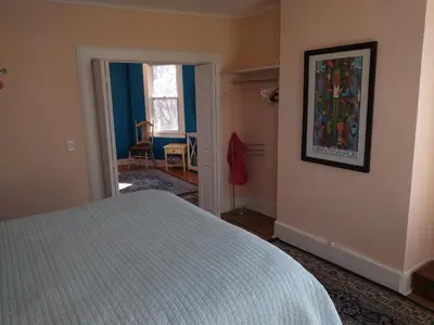 a bedroom with a bed and a painting on the wall at 3 Bedroom Apartment 30 Minutes to New York No Car Needed in Ridgefield Park