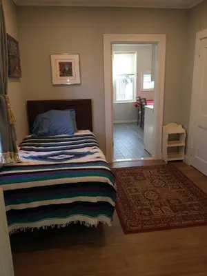 a bedroom with a bed with a striped blanket at 3 Bedroom Apartment 30 Minutes to New York No Car Needed in Ridgefield Park