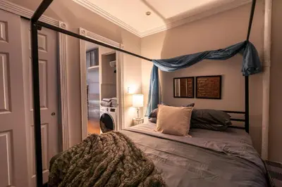 a bedroom with a bed with a canopy at Prestige Gramercy Park Suites in New York