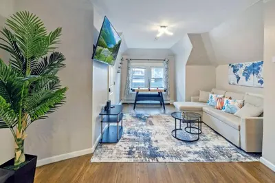 a living room with a couch and a table at Modern 2BR Near NYC with Free Parking and Workspace in East Orange