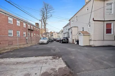 a street with cars parked on the side of a building at Modern 2BR Near NYC with Free Parking and Workspace in East Orange