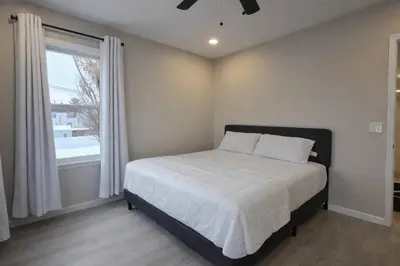a bedroom with a bed and a window at Bright Renovated 3BR Apartment w Private Entrance