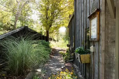a garden path next to a building with plants at The Arts & Crafts House with Skylights, Deck, Jetted Bathtub in Kingston