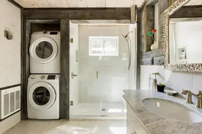 a bathroom with a washing machine and a sink at The Arts & Crafts House with Skylights, Deck, Jetted Bathtub in Kingston