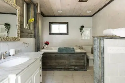 a bathroom with a tub and a sink and a toilet at The Arts & Crafts House with Skylights, Deck, Jetted Bathtub in Kingston