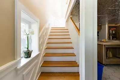 a staircase in a home with white walls and wooden floors at The Arts & Crafts House with Skylights, Deck, Jetted Bathtub in Kingston