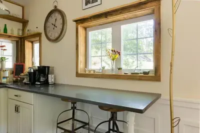 a kitchen with a counter and a clock on the wall at The Arts & Crafts House with Skylights, Deck, Jetted Bathtub in Kingston