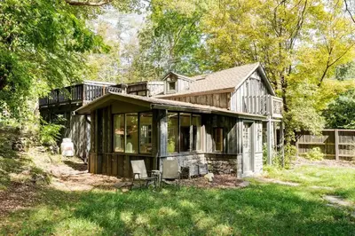 an old house with a chair in the yard at The Arts & Crafts House with Skylights, Deck, Jetted Bathtub in Kingston