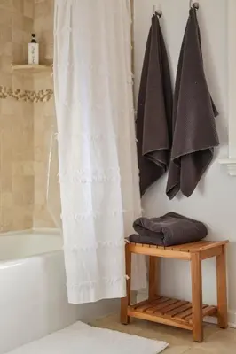 a bathroom with a white shower curtain and a wooden table at Minutes to Beaches - Home Theater, Couples Retreat in Milford