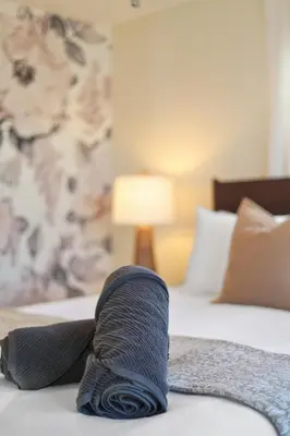 a tie laying on top of a bed at Minutes to Beaches - Home Theater, Couples Retreat in Milford