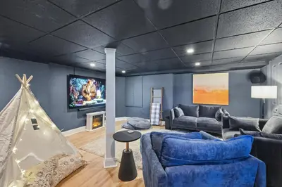a living room with a couch and a tv at Minutes to Beaches - Home Theater, Couples Retreat in Milford