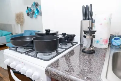 two pans sitting on top of a stove in a kitchen at Elegant84 West Side Home 5 min to Central Park in New York