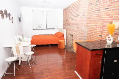 a room with a bed and a brick wall at West47 Village Getaway - Subway & Local Cafés in New York