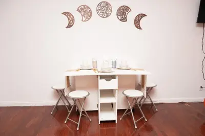 a table with stools in a room with a wall at West47 Village Getaway - Subway & Local Cafés in New York