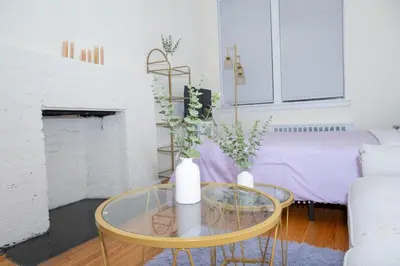 a living room with a glass table with two vases on it at Chic12 East Village Apartment Near Union Square Top Dining n Shopping in New York