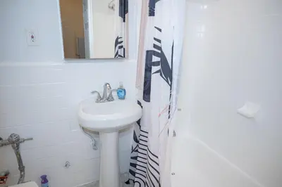 a bathroom with a sink and a shower curtain at Chic12 East Village Apartment Near Union Square Top Dining n Shopping in New York