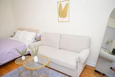 a living room with a couch and a bed at Chic12 East Village Apartment Near Union Square Top Dining n Shopping in New York