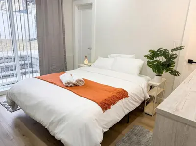 a bedroom with a bed with two towels on it at Easy-Access & Quick to NYC, EWR, Dream Mall, Stadium in Jersey City