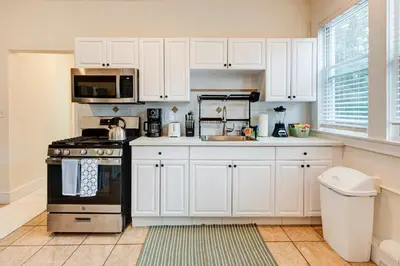 a kitchen with white cabinets and a stove at Serene Hamilton ELM 13MI to Time Square Laundry Easy Parking in Teaneck