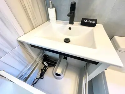 a bathroom with a white sink in a room at Madison Ave Oasis in New York