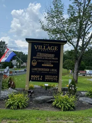 a sign for a village in a park at Cozy stream-side cabin in Lanesborough
