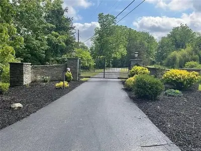 a driveway with a gate in a house at Lucious Lagrangeville in Lagrangeville