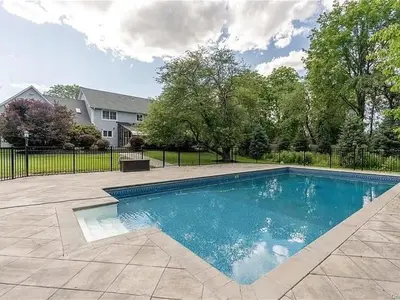 a swimming pool in front of a house at Lucious Lagrangeville in Lagrangeville