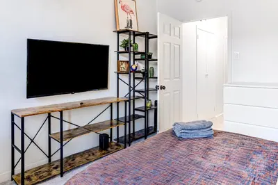 a living room with a flat screen tv on a wall at 4 BD Family Unit in Central Location in New York
